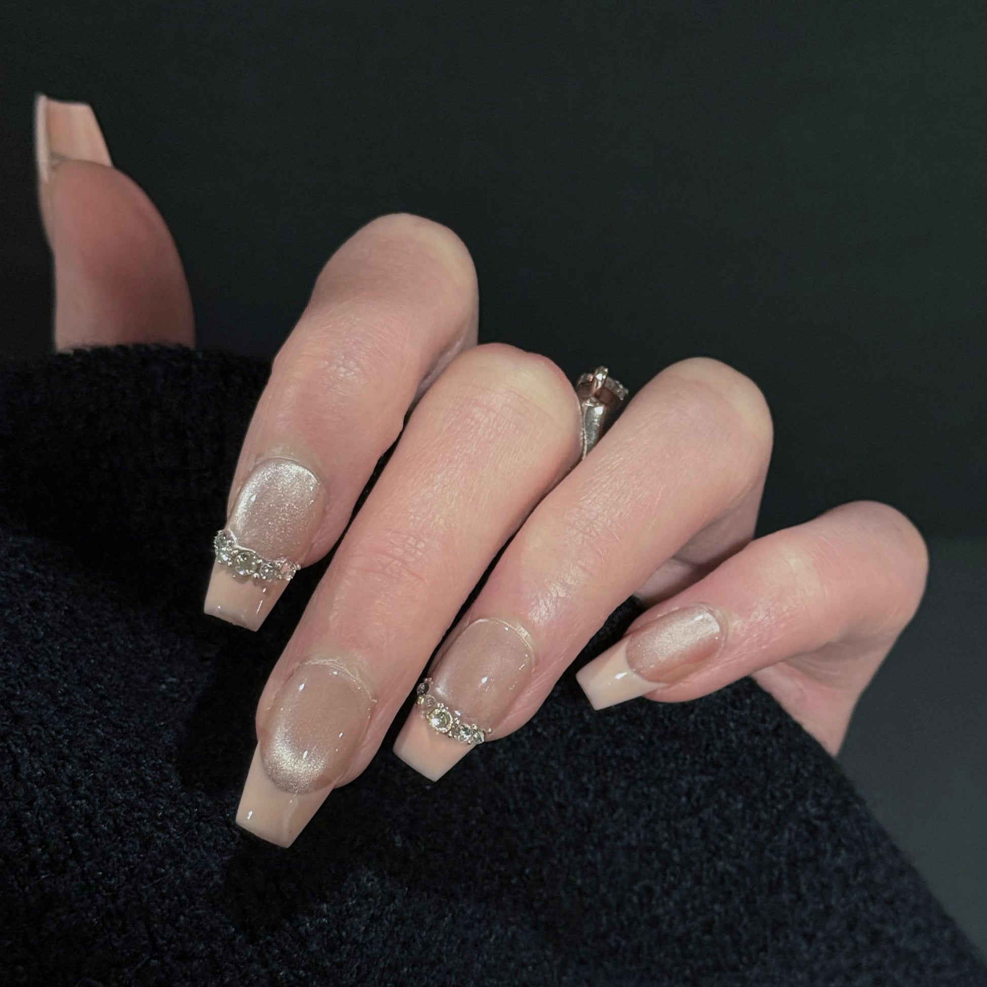 Athena French Tip Cat Eye Press-On Nails – Soft Nude with Gems Chain, Worn on Hand