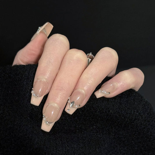 Chain of Hearts Gems French Tip Press-On Nails – Nude Base with Pearls & Teardrop Accents, Worn on Hand