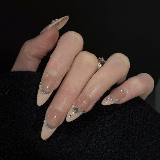 Chain of Hearts Gems French Tip Press-On Nails – Nude Base with Pearls & Teardrop Accents, Worn on Hand