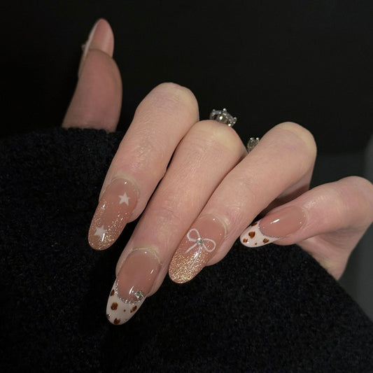 Cowgirls French Tip Cat Eye Press-On Nails – Warm Nude with Star & Pink Bow Accents, Worn on Hand