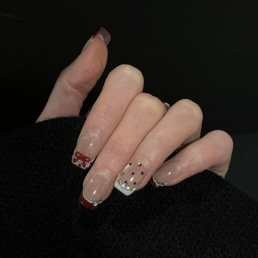 Crimson Dot French Tip Press-On Nails – Nude Base with Crimson Tips, Gems Accents and 3D Red Bow, Worn on Hand