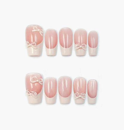 Ballerina Press-On Nails – Nude Base French Tip with 3D White Bow Charms, medium Coffin Full-Cover Set