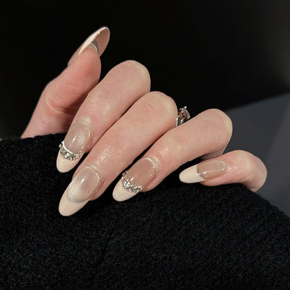 Athena French Tip Cat Eye Press-On Nails – Soft Nude with Gems Chain, Worn on Hand