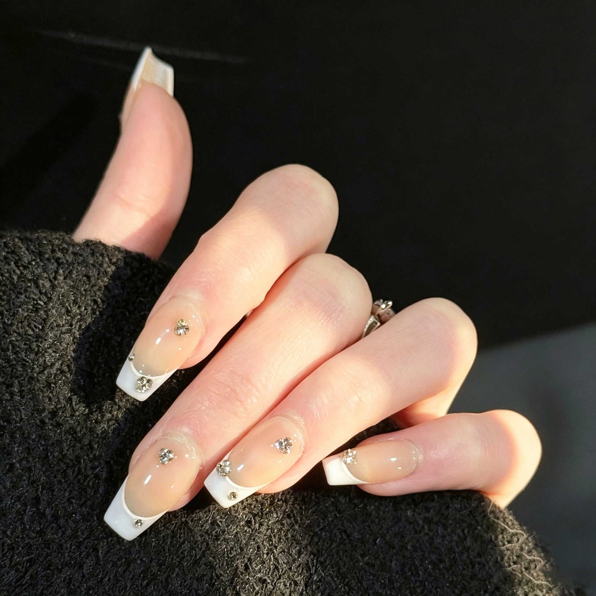 Gems Dew French Tip Gems Press-On Nails – Nude with Light Purple Tips & Gems Accents, Worn on Hand