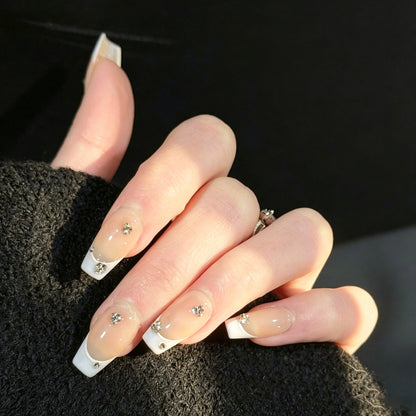 Gems Dew French Tip Gems Press-On Nails – Nude with Light Purple Tips & Gems Accents, Worn on Hand