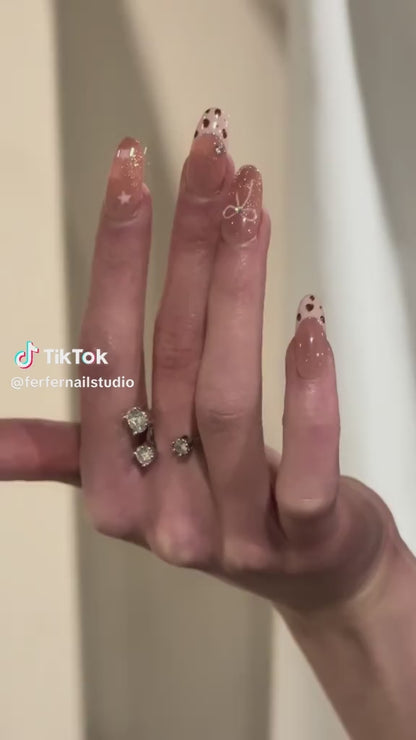 Video: Cowgirls Press-On Nails – Warm Nude French Tip with Star & Pink Bow Accents, Medium Oval Nails, Showing Application and Wear